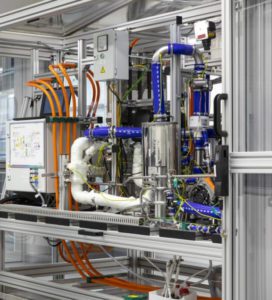 A machine with many pipes and wires on it