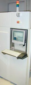 A computer monitor and keyboard on the wall.